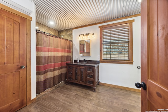 bathroom with hardwood / wood-style floors, a shower with curtain, and vanity