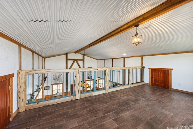 interior space with dark hardwood / wood-style floors and vaulted ceiling with beams