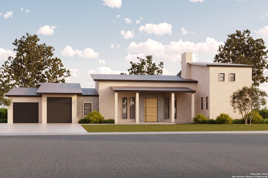 view of front of property featuring a front yard, solar panels, and a garage