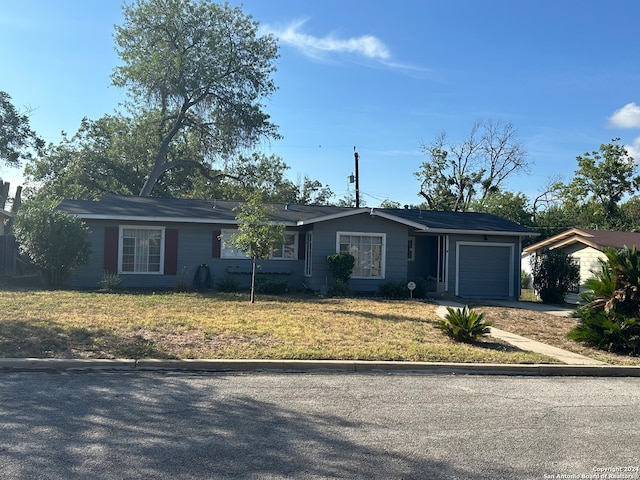 single story home featuring a front lawn and a garage