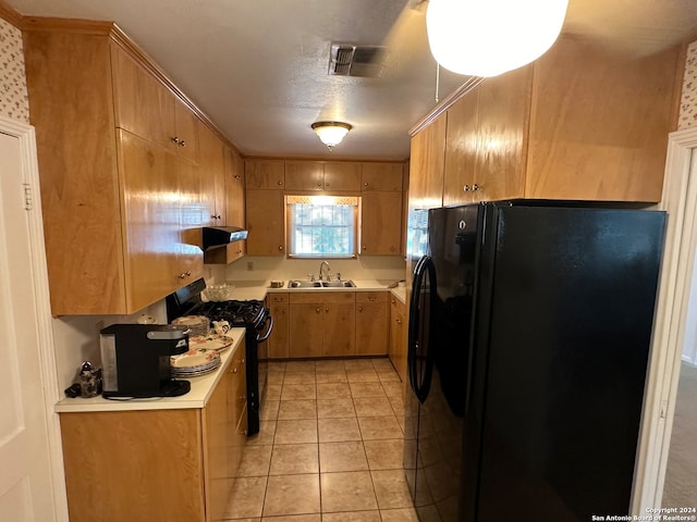 kitchen with black appliances, sink, light tile patterned floors, and extractor fan