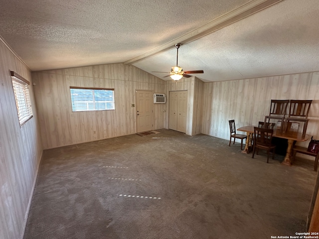 carpeted spare room featuring a textured ceiling, ceiling fan, and lofted ceiling