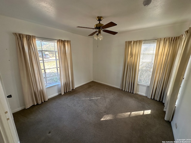 carpeted spare room with ceiling fan