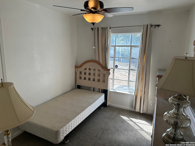 carpeted bedroom with ceiling fan and multiple windows