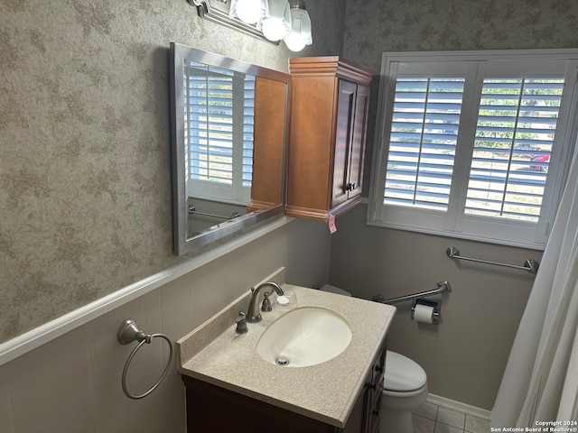 bathroom with vanity, toilet, and tile patterned floors