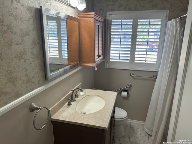 bathroom with tile patterned flooring, toilet, and vanity