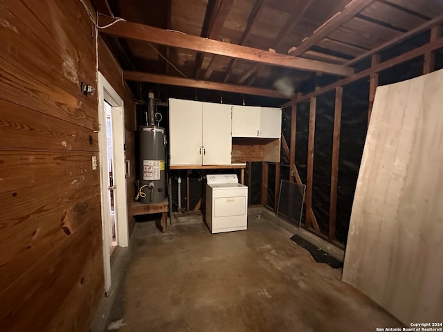 interior space featuring washer / dryer, wooden walls, and water heater