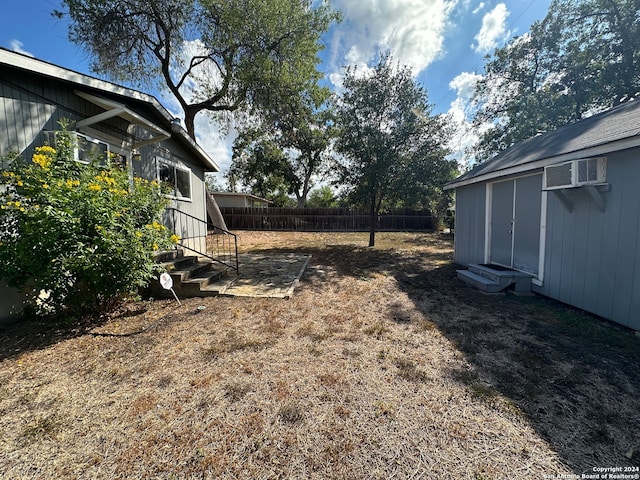 view of yard with an AC wall unit