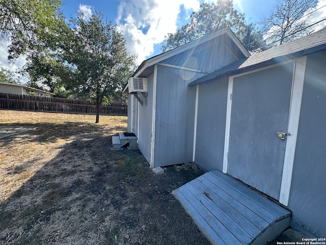 view of outbuilding featuring a wall unit AC