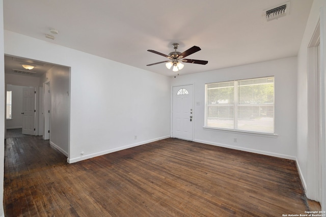 empty room with dark wood-type flooring and ceiling fan