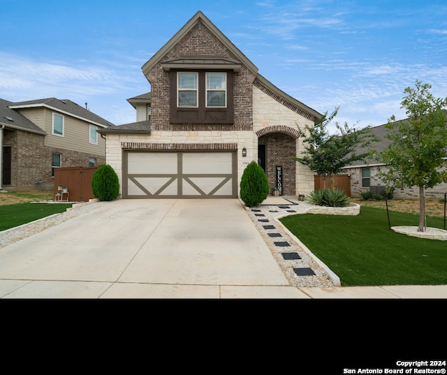 view of front of house featuring a garage and a front yard