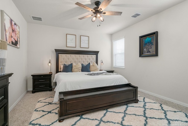 bedroom with light carpet, visible vents, and baseboards