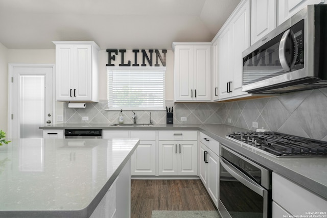 kitchen with white cabinets, stainless steel appliances, dark hardwood / wood-style flooring, and sink