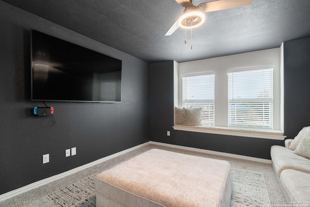 interior space featuring a textured ceiling, baseboards, and a ceiling fan