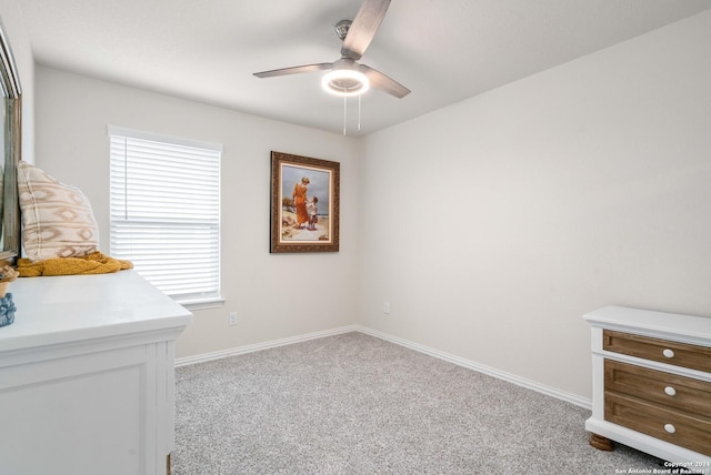 carpeted bedroom with baseboards and a ceiling fan