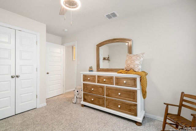 bedroom with visible vents, baseboards, light colored carpet, and a closet