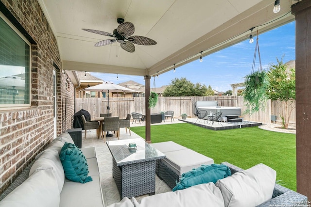 view of patio with an outdoor living space, a hot tub, a fenced backyard, outdoor dining space, and a ceiling fan