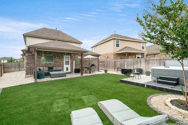 back of property with an outdoor living space, a fenced backyard, a hot tub, a patio area, and brick siding