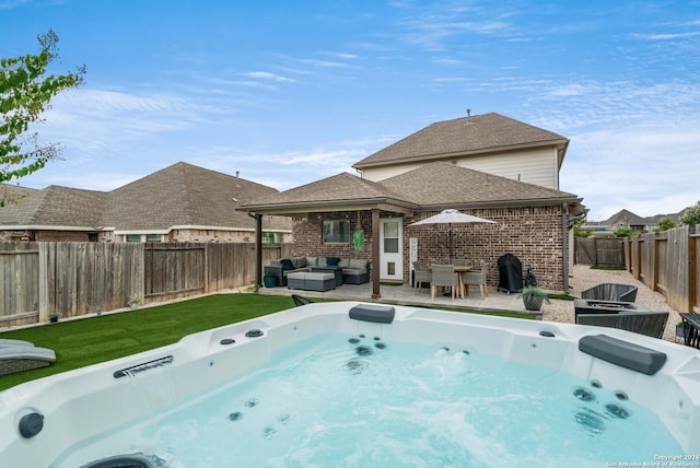 view of swimming pool featuring a fenced backyard, a yard, a patio area, outdoor lounge area, and a hot tub