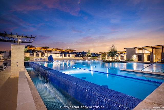 view of pool at dusk