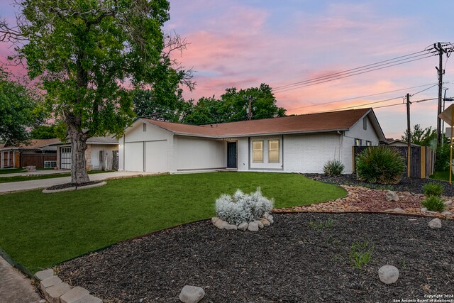 ranch-style home featuring a yard