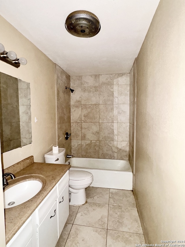 full bathroom with tile patterned floors, tiled shower / bath, toilet, and vanity