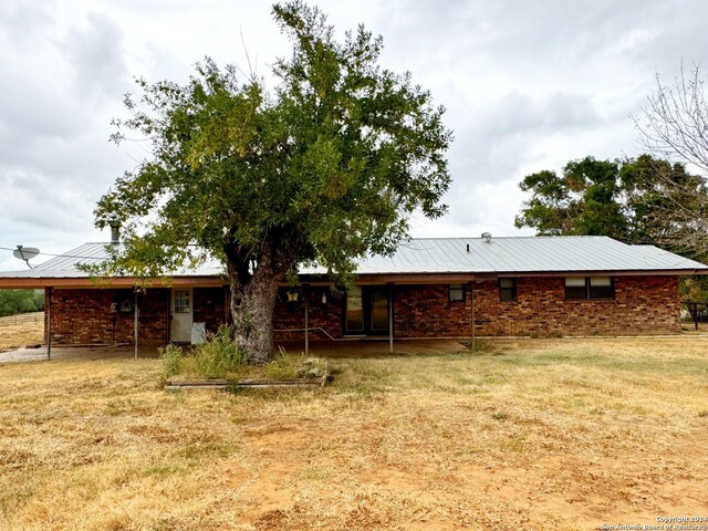 rear view of house with a lawn