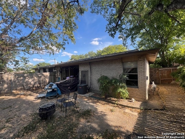 rear view of house with a fire pit