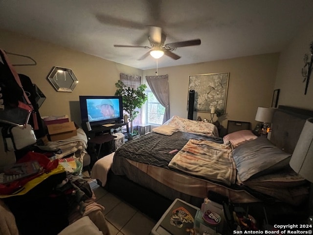 bedroom with ceiling fan and light tile patterned floors