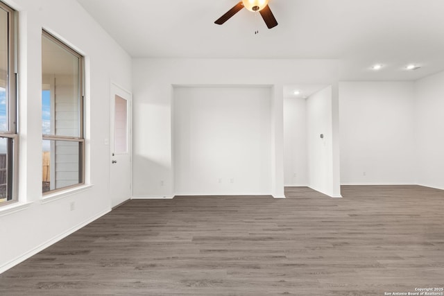 empty room featuring recessed lighting, a healthy amount of sunlight, ceiling fan, and wood finished floors