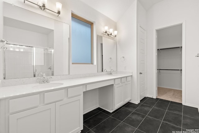 full bath featuring tile patterned flooring, a sink, a spacious closet, a shower stall, and double vanity