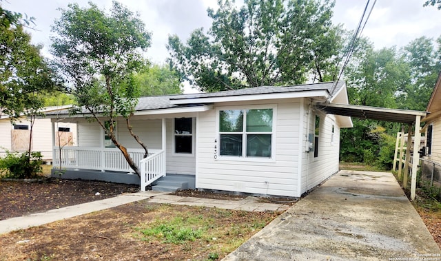 view of front of home with a carport and covered porch