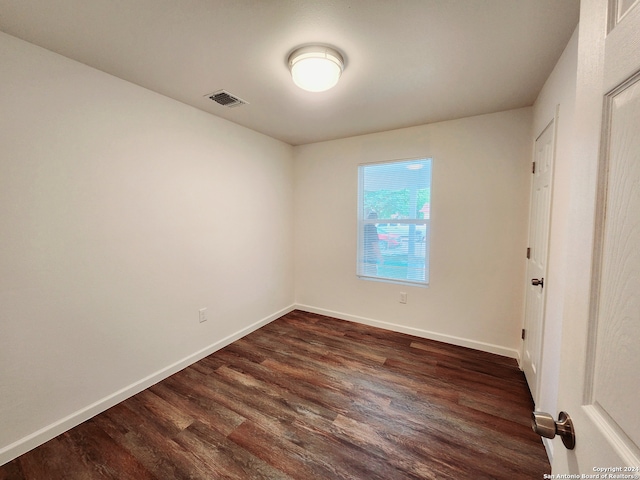 spare room featuring dark hardwood / wood-style floors