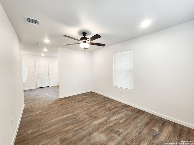 empty room with dark wood-type flooring and ceiling fan