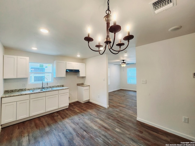 kitchen with ceiling fan with notable chandelier, hanging light fixtures, white cabinets, and dark hardwood / wood-style floors