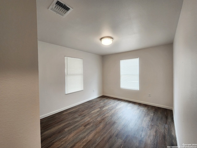 spare room featuring dark hardwood / wood-style flooring