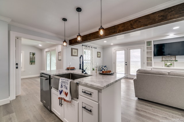 kitchen featuring a wealth of natural light, pendant lighting, light hardwood / wood-style flooring, and french doors