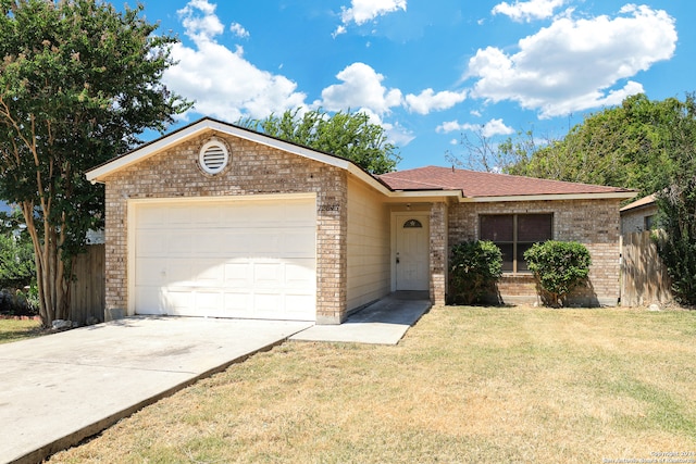 single story home featuring a garage and a front yard