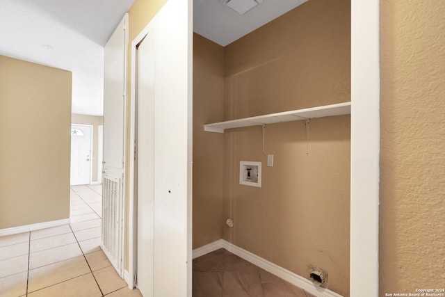 laundry area featuring hookup for a washing machine and light tile patterned floors