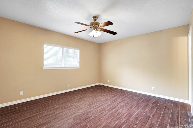 unfurnished room featuring ceiling fan, a textured ceiling, and dark wood-type flooring