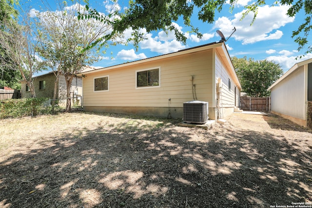 back of house featuring central AC unit