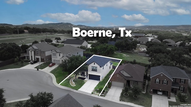 drone / aerial view featuring a mountain view and a residential view