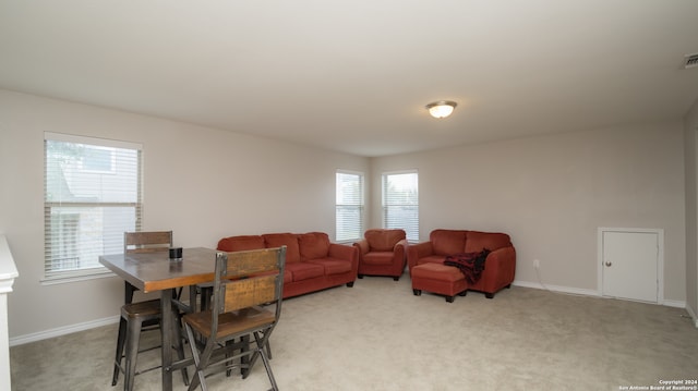 living room featuring a wealth of natural light and light carpet