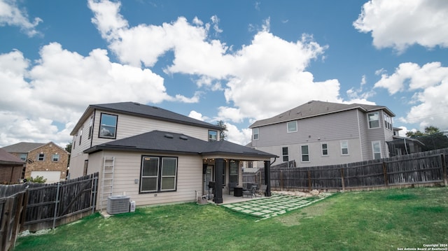 rear view of house featuring a yard, a patio area, and central air condition unit