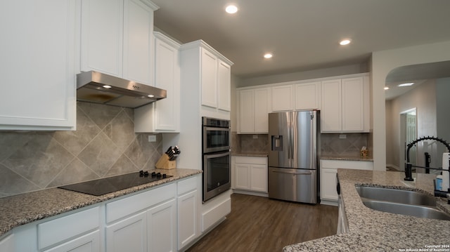 kitchen featuring appliances with stainless steel finishes, white cabinetry, sink, and dark wood-type flooring