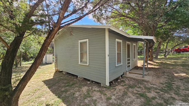 view of home's exterior with a storage unit