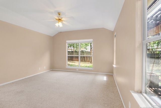 carpeted empty room with ceiling fan and vaulted ceiling