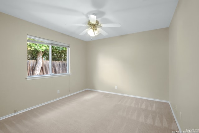 spare room featuring ceiling fan and carpet