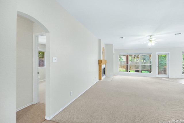 carpeted spare room with ceiling fan