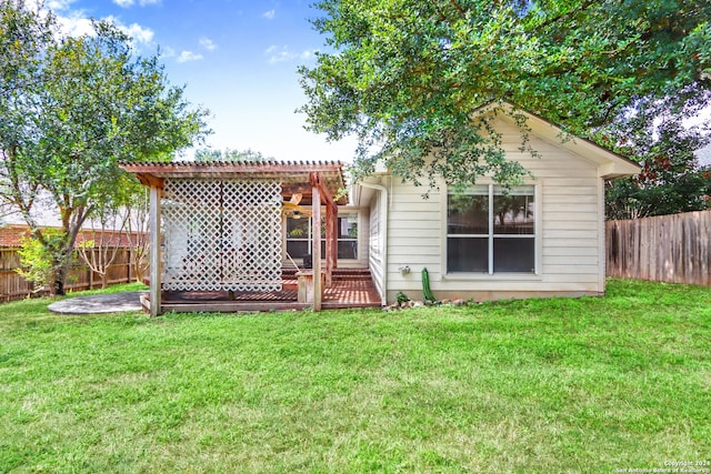 back of house featuring a yard